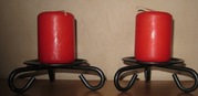 Red candles on black metal candlesticks.